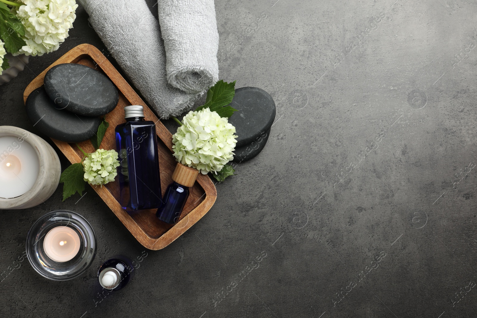 Photo of Flat lay composition with spa products on gray table, space for text