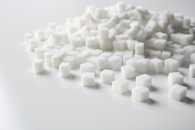 Refined sugar cubes on light background