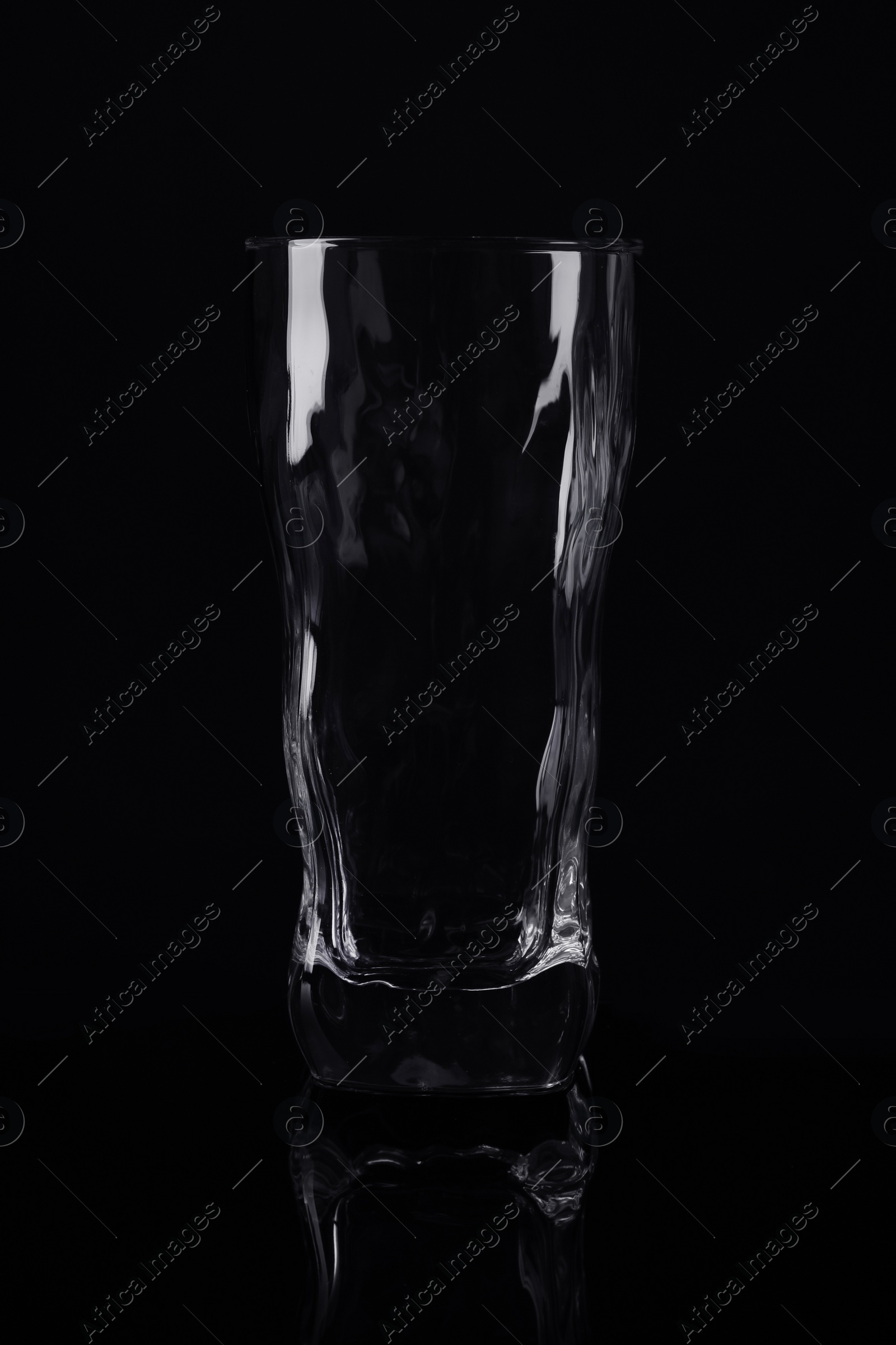 Photo of New empty tall glass on black background