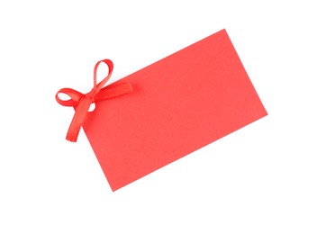 Blank red gift tag with satin ribbon on white background, top view