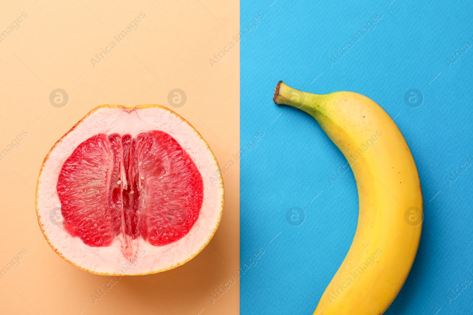 Photo of Banana and half of grapefruit on color background, flat lay. Sex concept