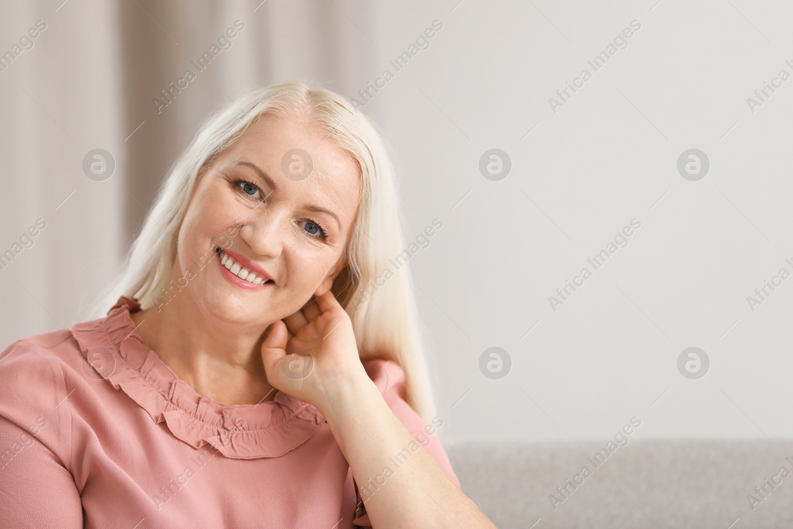 Photo of Portrait of beautiful older woman against blurred background with space for text