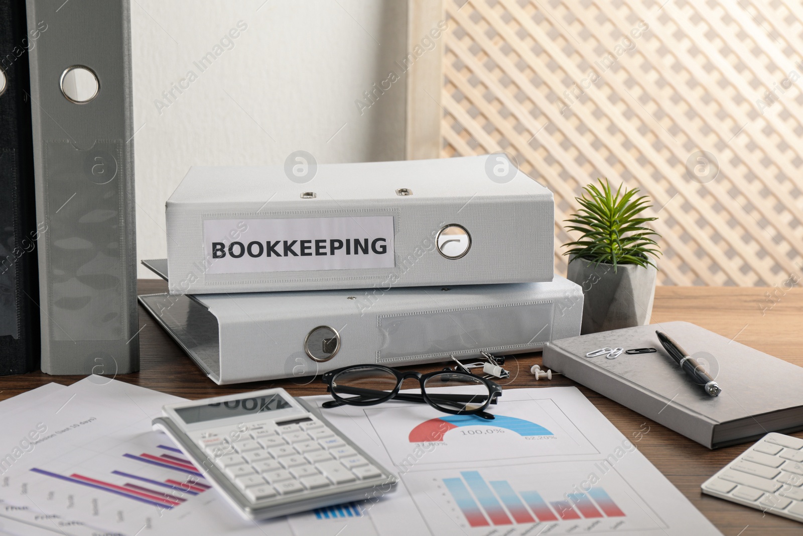 Photo of Bookkeeper's workplace with folders and documents on table