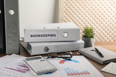 Photo of Bookkeeper's workplace with folders and documents on table