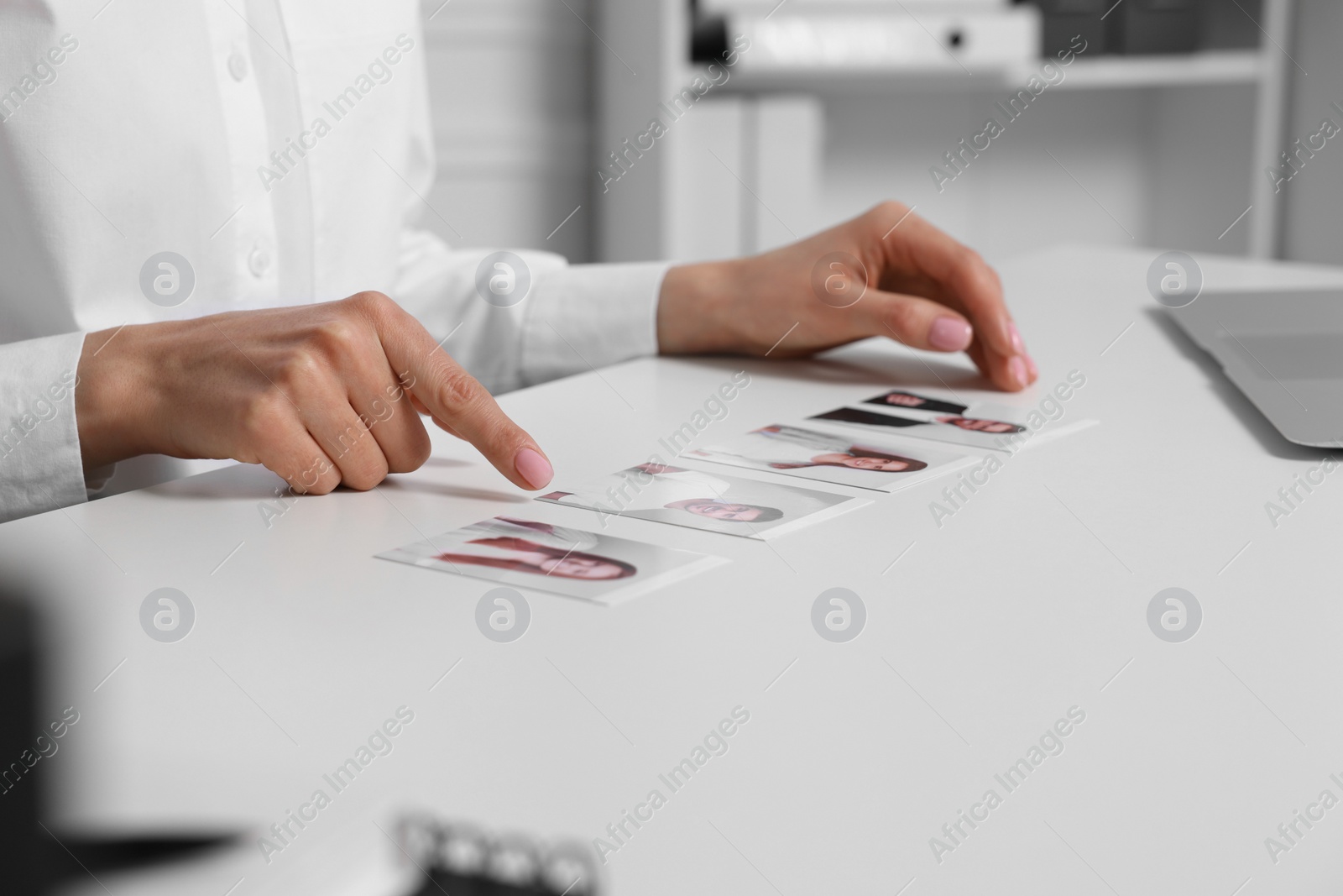 Photo of Human resources manager choosing employee among different applicants at table in office, closeup