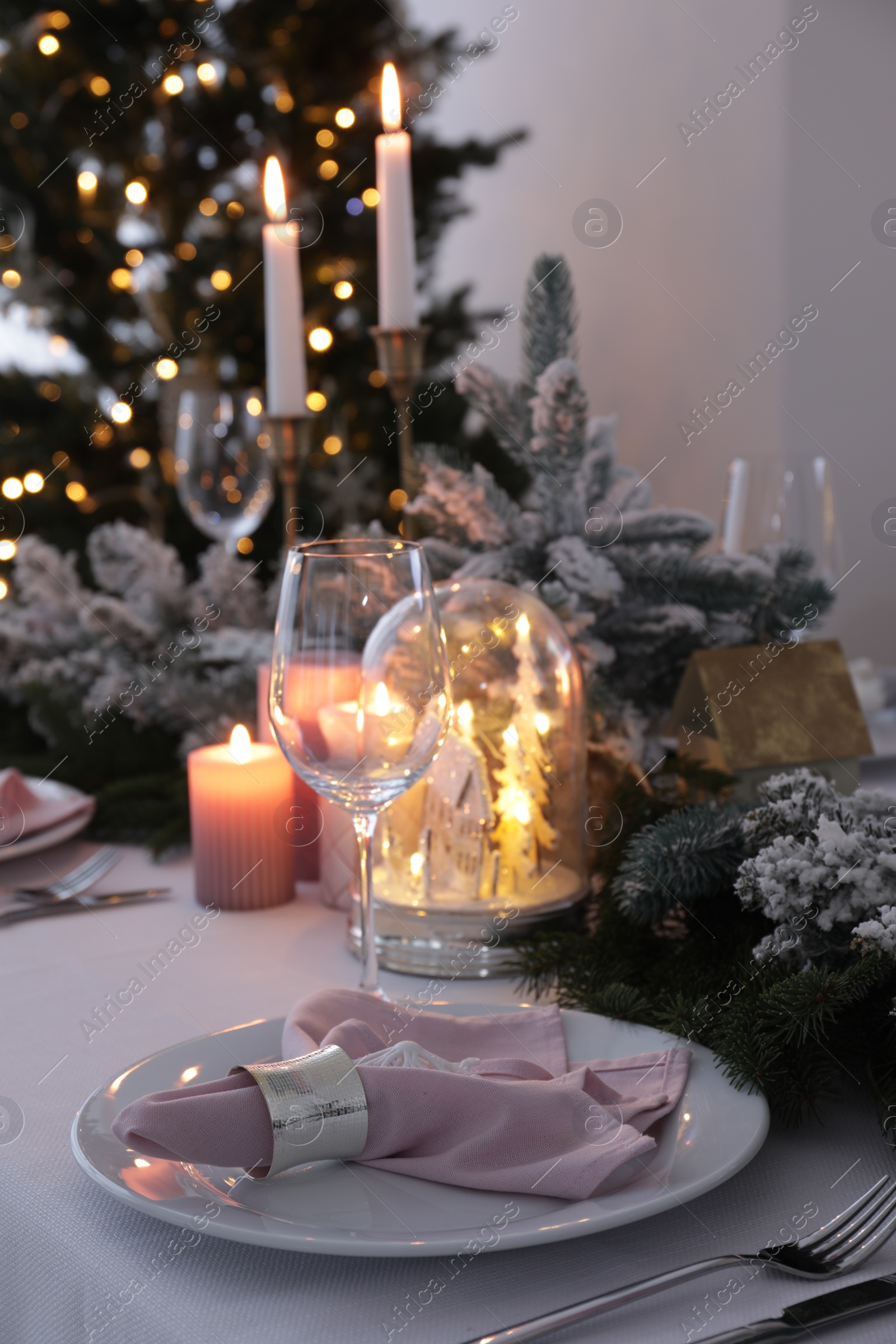 Photo of Beautiful festive place setting with Christmas decor on table indoors