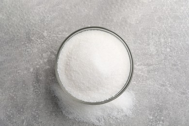 Granulated sugar on light grey table, top view