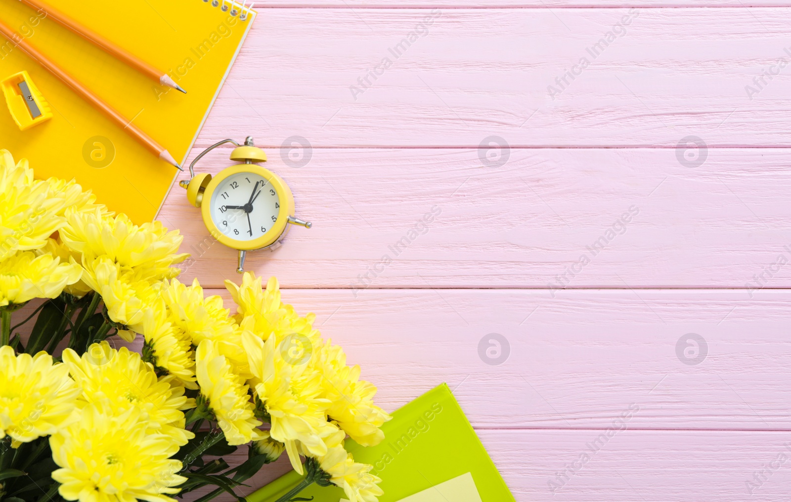 Photo of Beautiful flowers and stationery on pink wooden background, flat lay with space for text. Teacher's Day