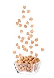 Raw chickpeas falling into bowl on white background