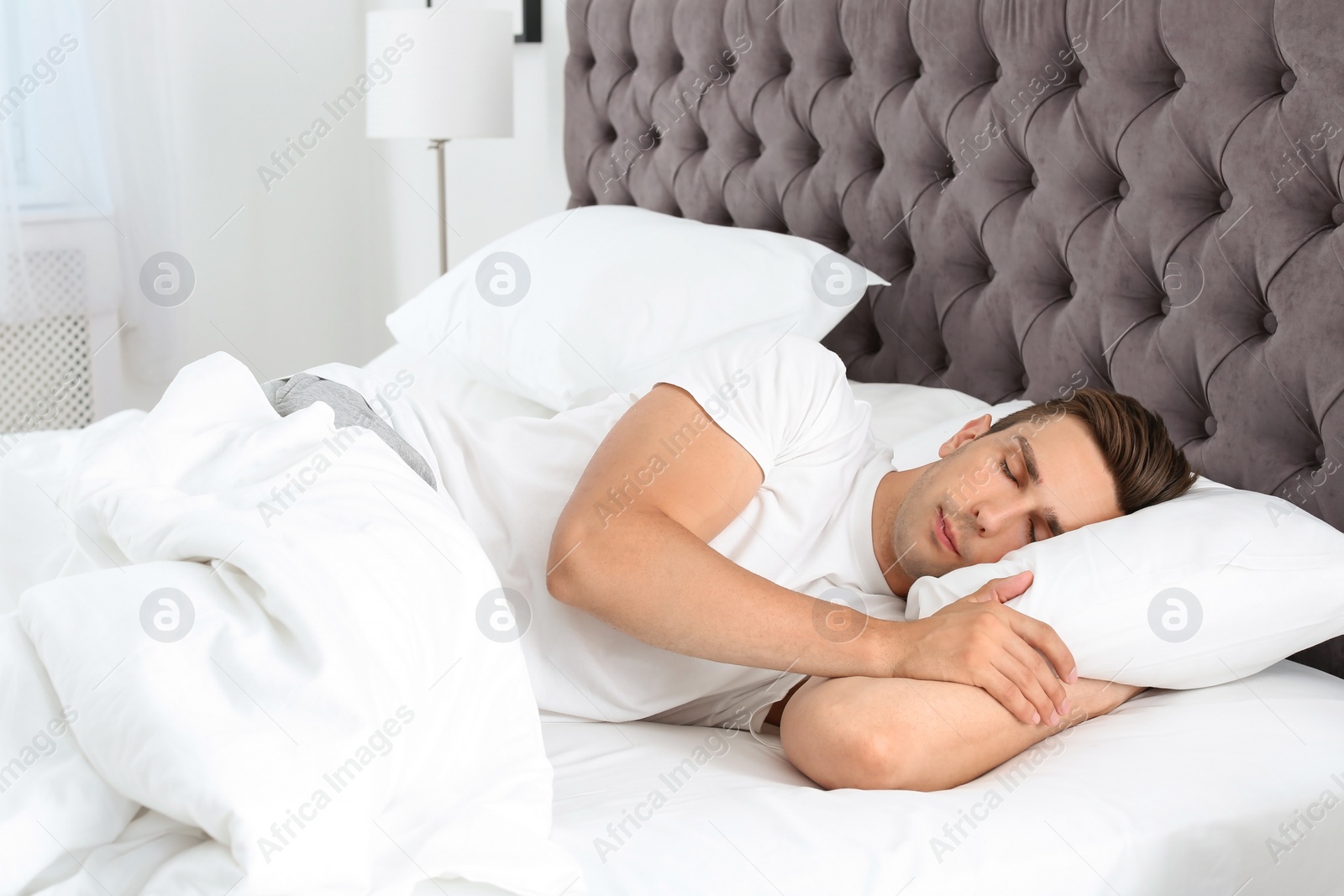 Photo of Young man sleeping in bed at home