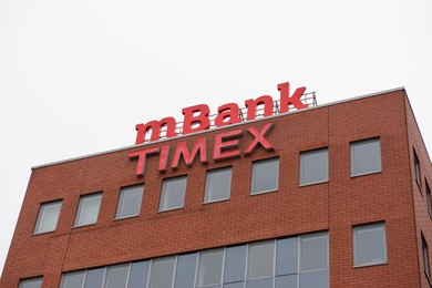 Photo of Warsaw, Poland - September 10, 2022: Building with modern Mbank and Timex logos