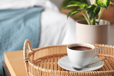 Fresh coffee and green plant in bedroom. Home decoration