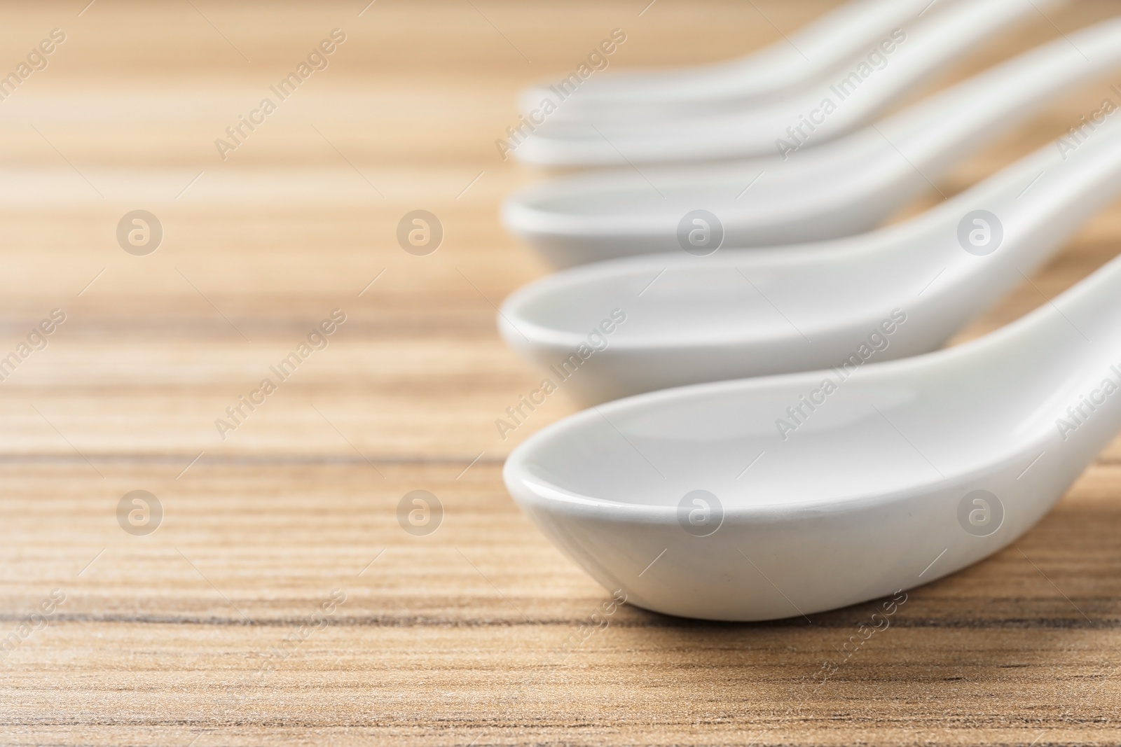 Photo of Miso soup spoons on wooden table. Space for text