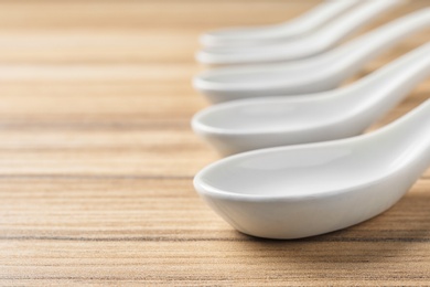 Miso soup spoons on wooden table. Space for text