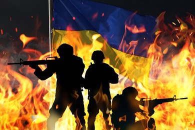 Image of Silhouettes of military men, flag of Ukraine and flame, double exposure