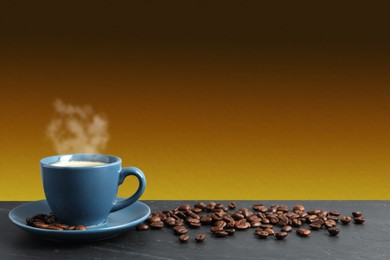 Cup of hot aromatic coffee and roasted beans on black table against brown background. Space for text