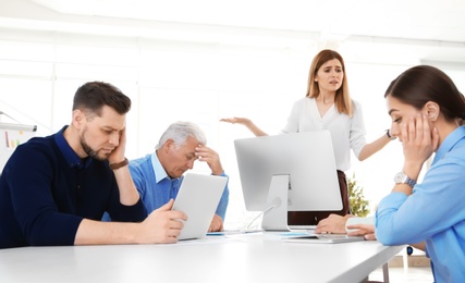 Photo of Office employees having argument during business meeting