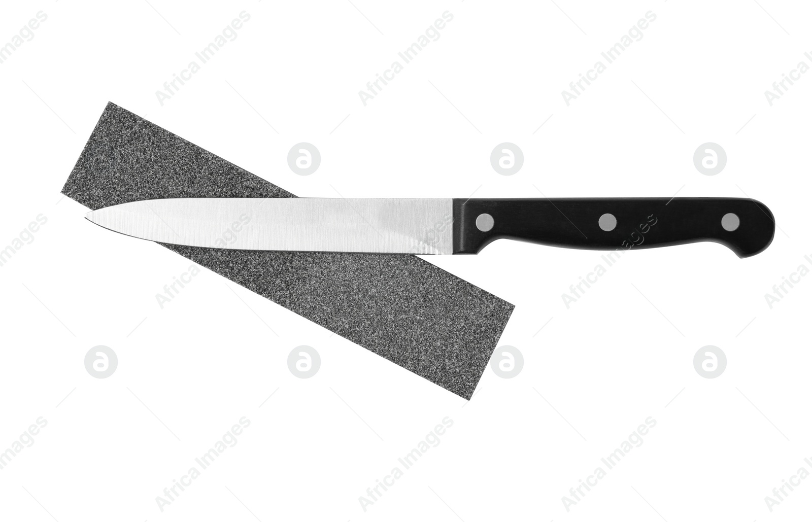 Photo of Utility knife and grindstone isolated on white, top view