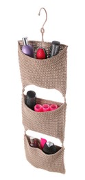 Photo of Stylish knitted organizer with toiletries and hair brushes on white background. Bath accessory