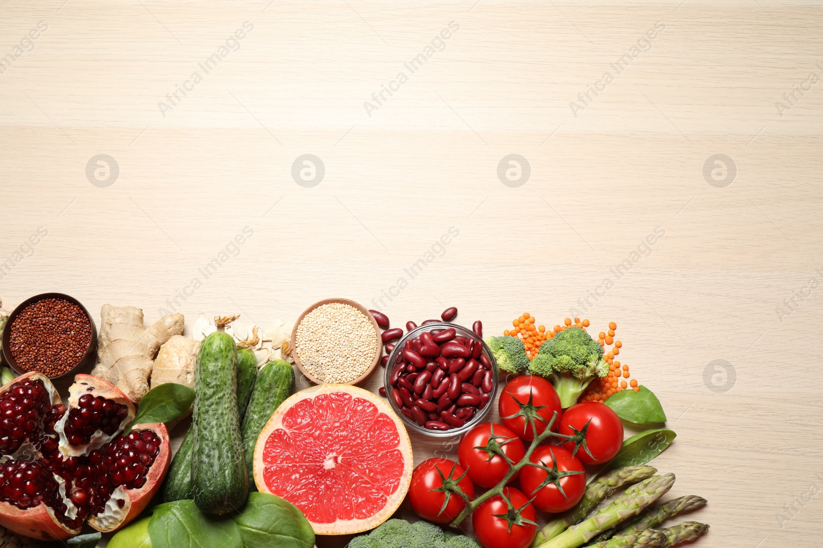 Photo of Fresh vegetables, seeds and grapefruit on light table, flat lay