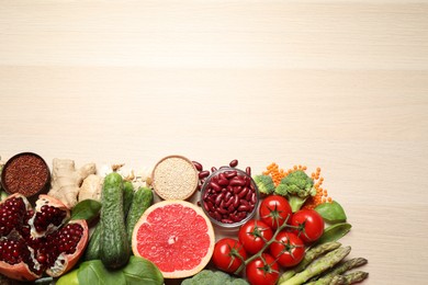 Fresh vegetables, seeds and grapefruit on light table, flat lay