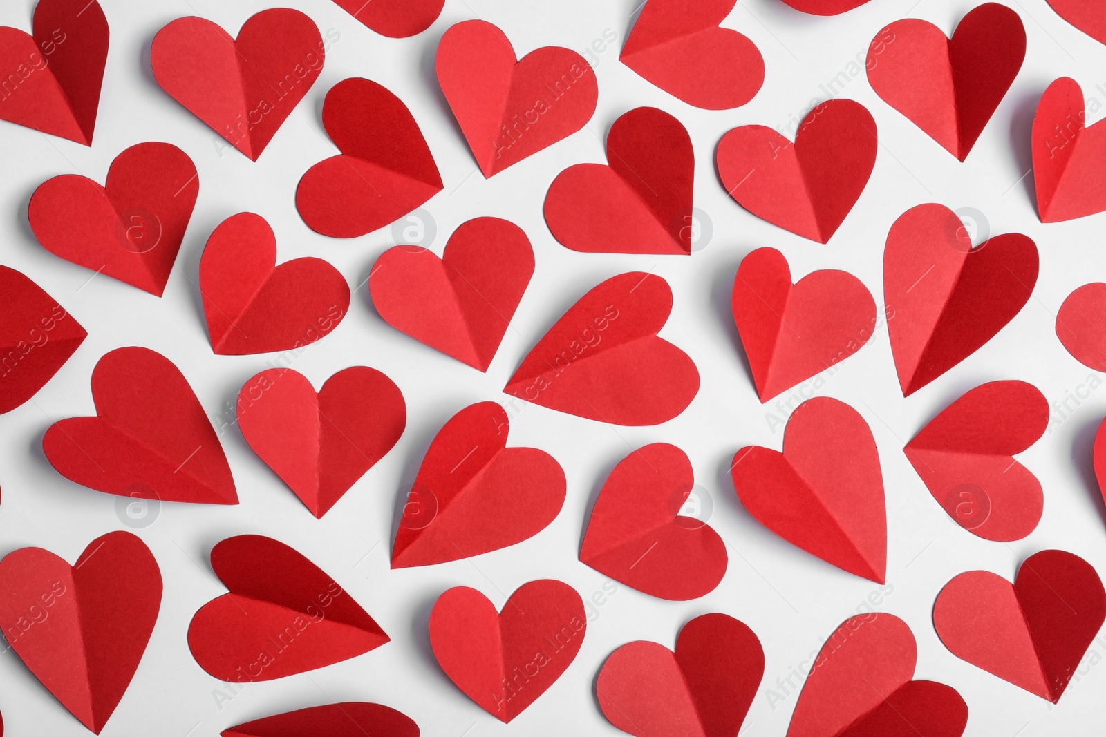 Photo of Flat lay composition of paper hearts on white background