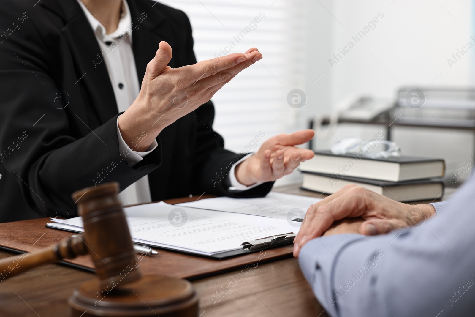 Photo of Senior man having meeting with lawyer in office, closeup