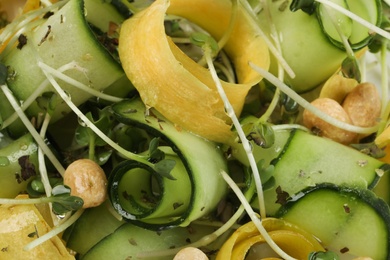 Photo of Closeup view of delicious fresh carrot salad with cucumber