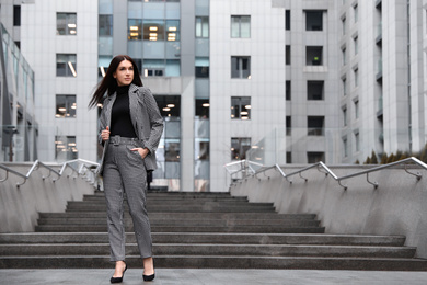 Photo of Full length portrait of beautiful woman in stylish suit outdoors. Space for text