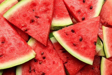 Photo of Slices of juicy ripe watermelon as background, top view