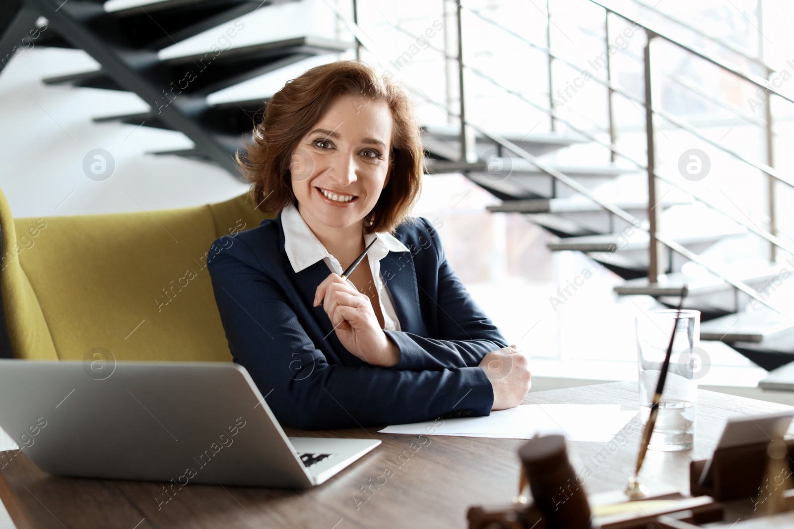 Photo of Female lawyer working at table in office