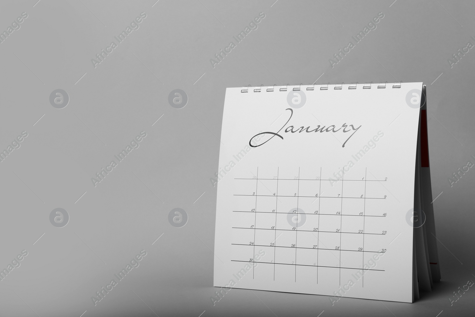 Photo of Paper calendar on grey background, space for text. Planning concept