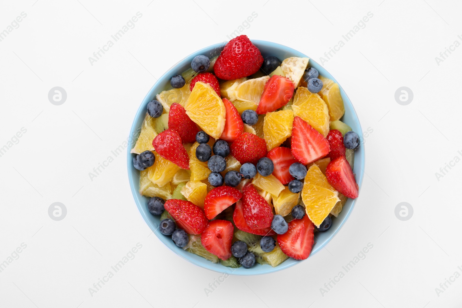 Photo of Yummy fruit salad in bowl on white background, top view