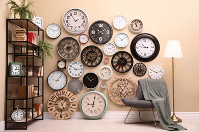 Stylish room interior with collection of wall clocks