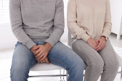 Couple waiting for appointment with STD specialist in clinic, closeup