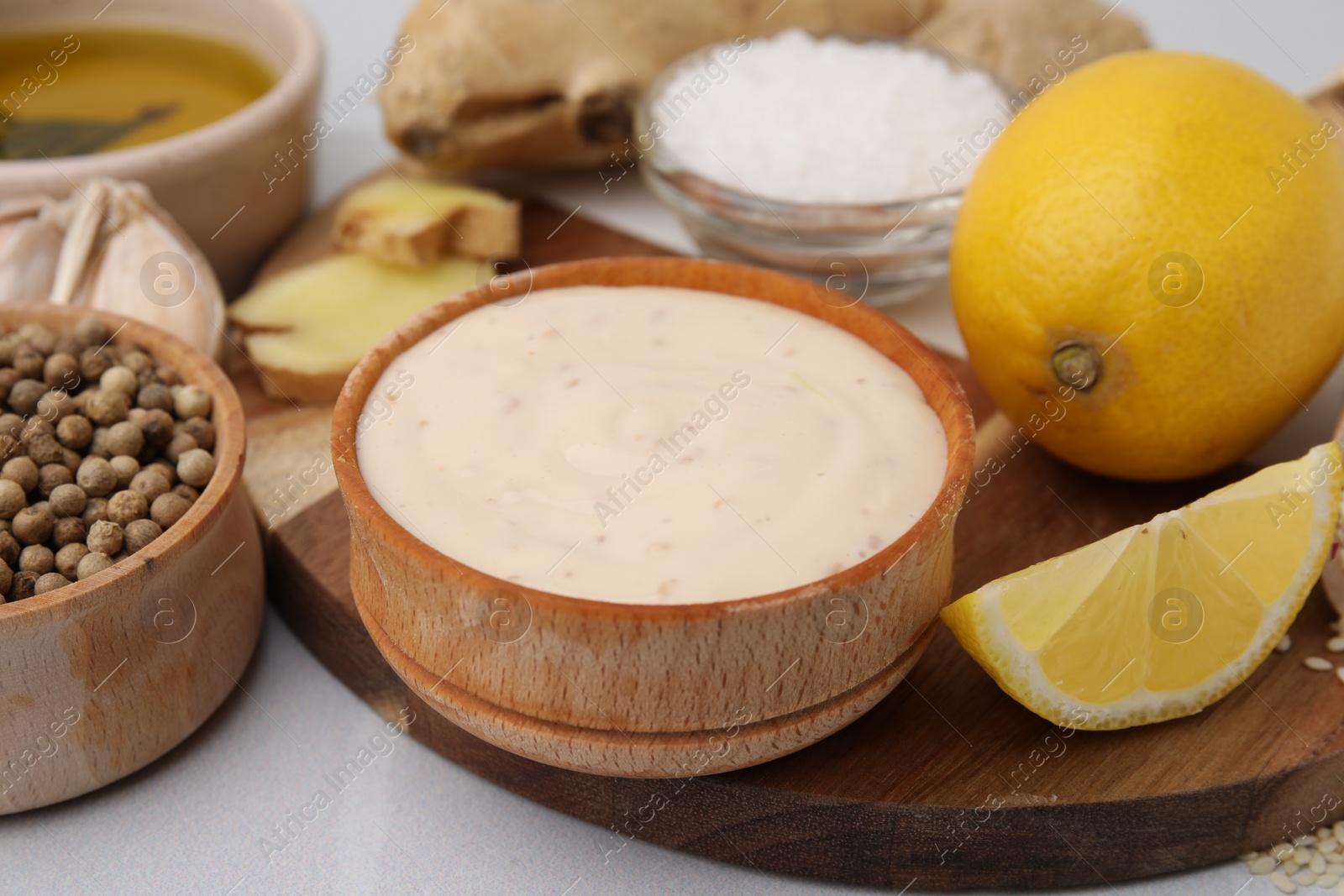 Photo of Fresh marinade and different ingredients on white table, closeup