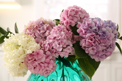 Bouquet of beautiful hydrangea flowers in vase indoors, closeup