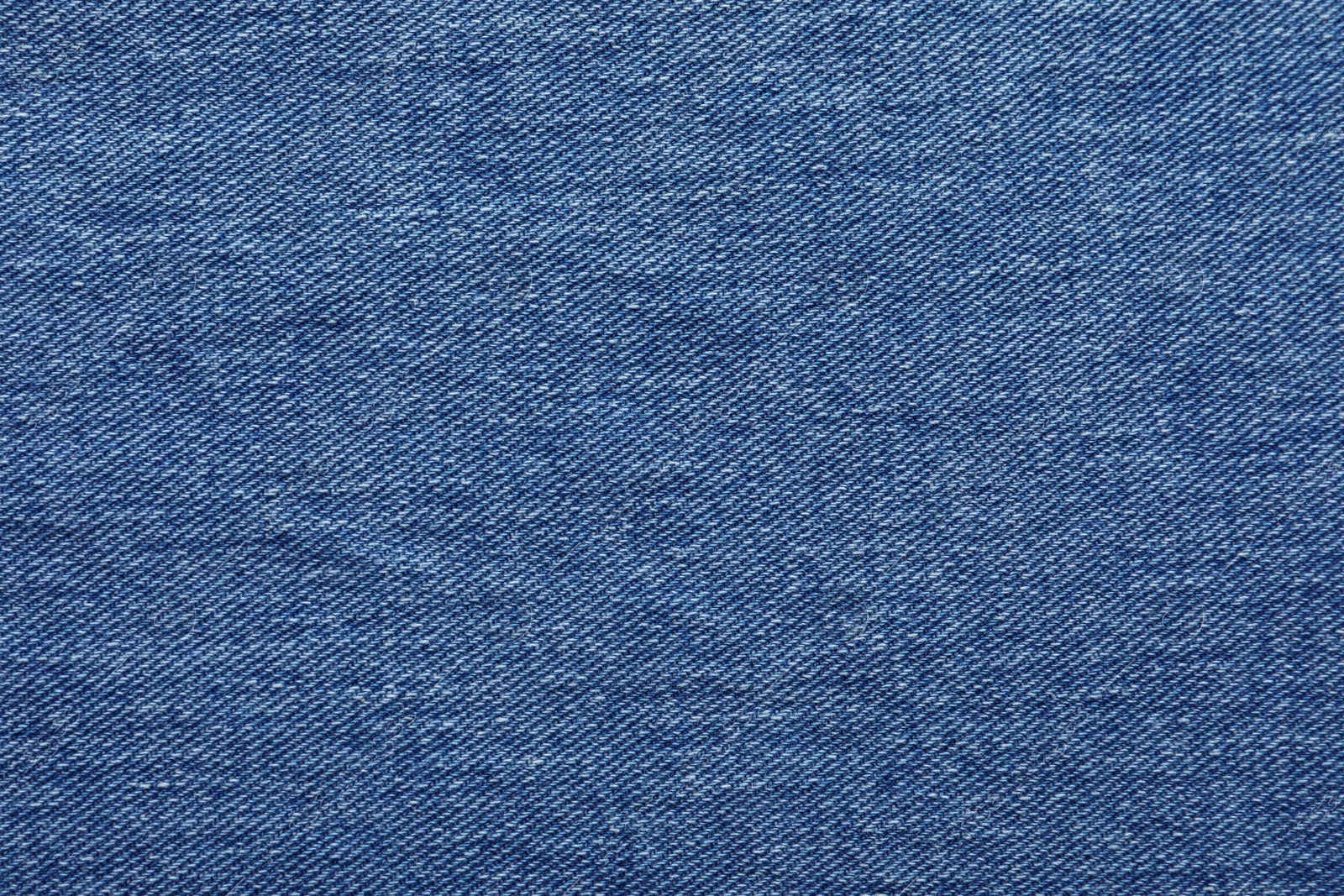 Photo of Texture of blue jeans as background, closeup