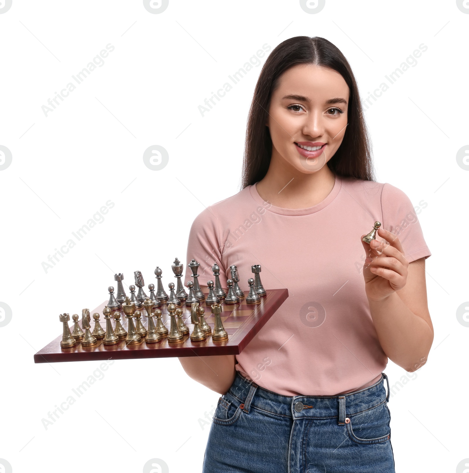 Photo of Happy woman holding chessboard with game pieces on white background