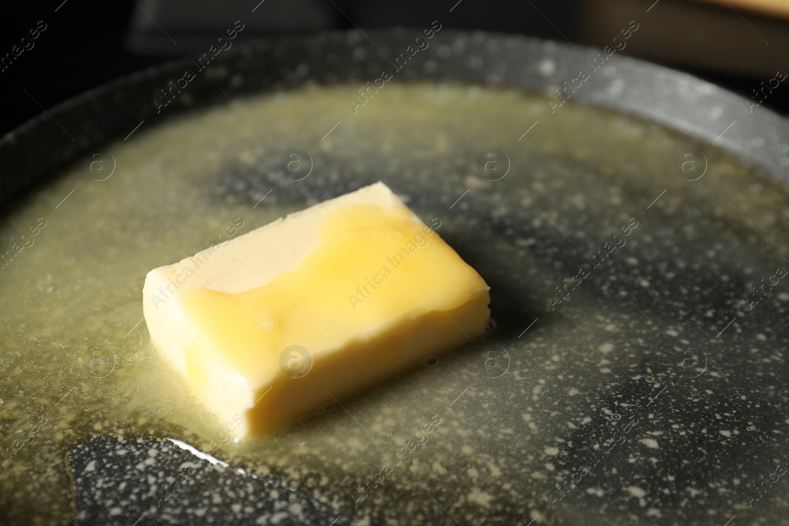 Photo of Melting butter in frying pan, closeup view