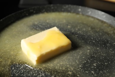 Photo of Melting butter in frying pan, closeup view