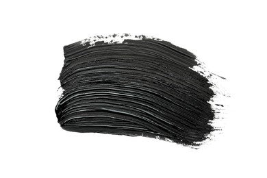 Photo of Brushstrokes of black oil paint on white background, top view