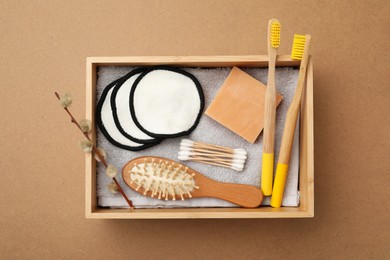 Photo of Wooden box with eco friendly products on craft paper, top view