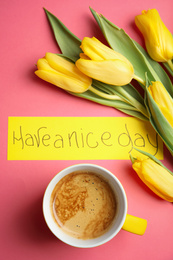 Photo of Delicious morning coffee, beautiful flowers and card with HAVE A NICE DAY wish on pink background, flat lay