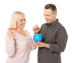 Photo of Happy senior couple with piggy bank on white background