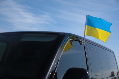 National flag of Ukraine on car window outdoors