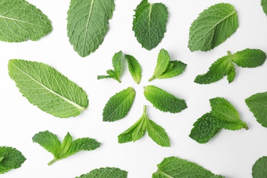 Flat lay composition with fresh green mint leaves on white background