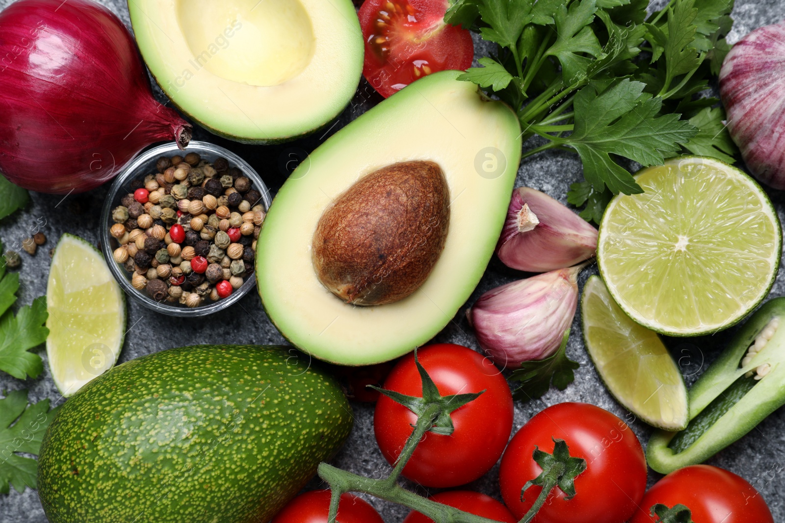 Photo of Fresh ingredients for guacamole on grey table, flat lay