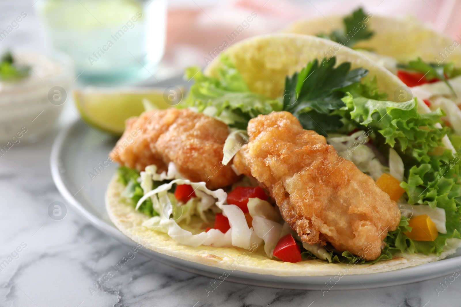 Photo of Yummy fish tacos served on table, closeup