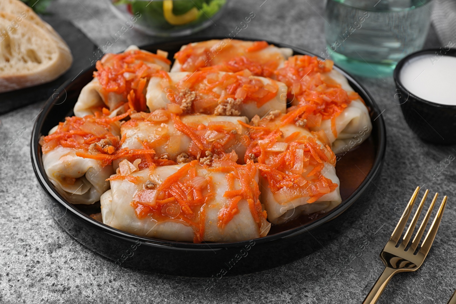 Photo of Delicious cabbage rolls served on grey table, closeup